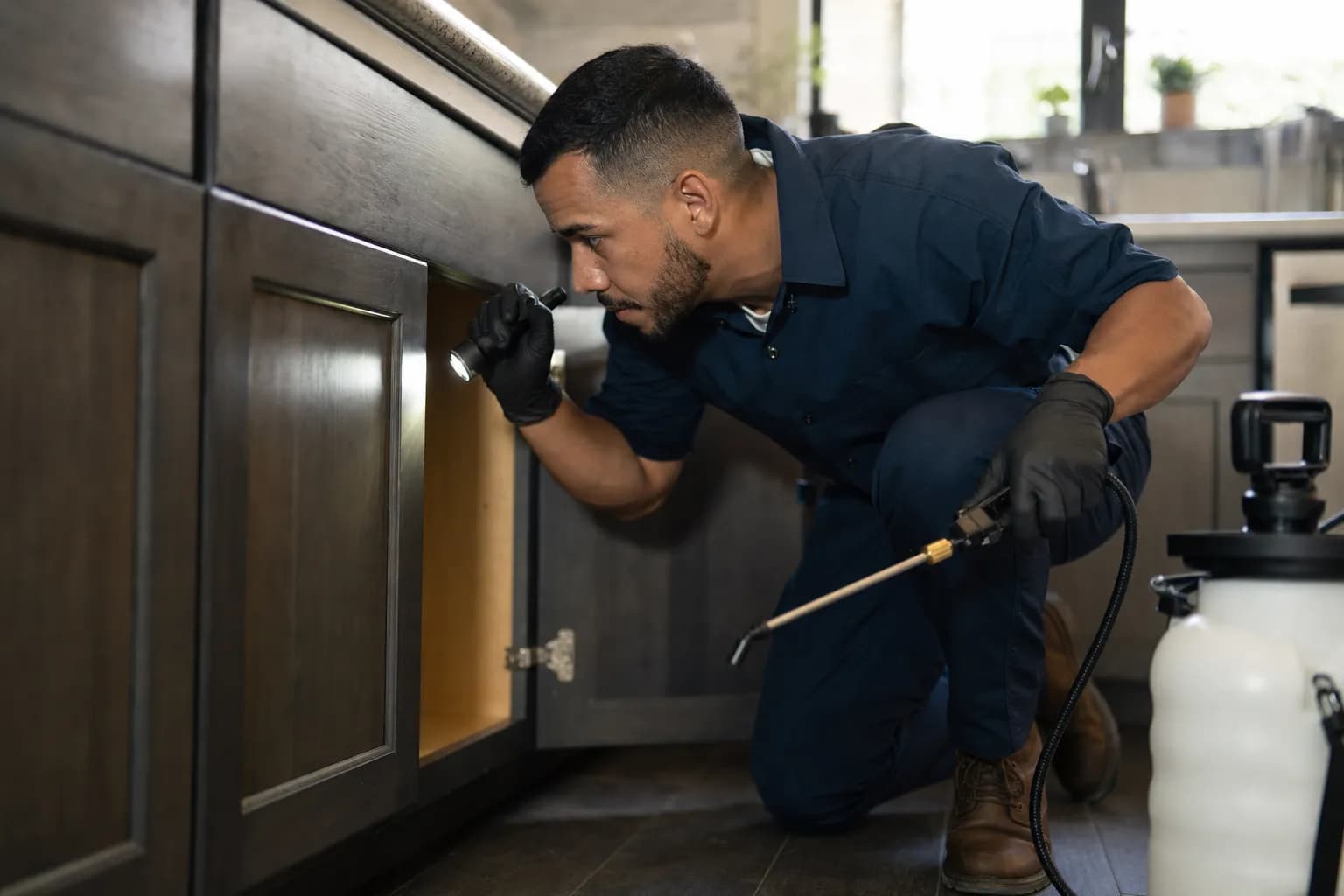 Pest control technician treating a home while Callbook answers urgent infestation calls from customers